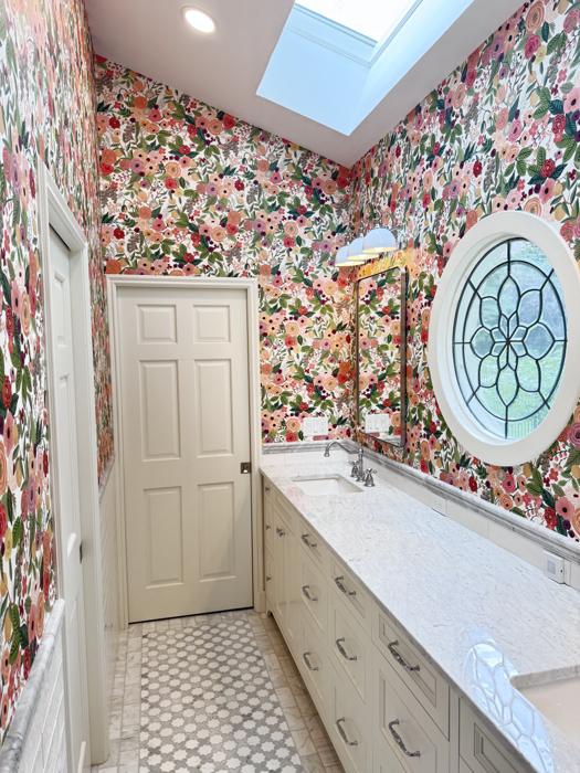 Bright floral bathroom with skylight and round window