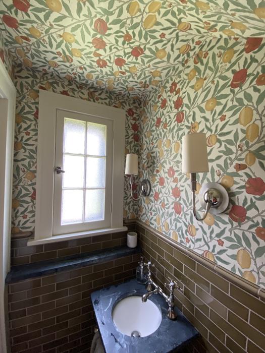 Fruit and vine wallpaper in a small bathroom