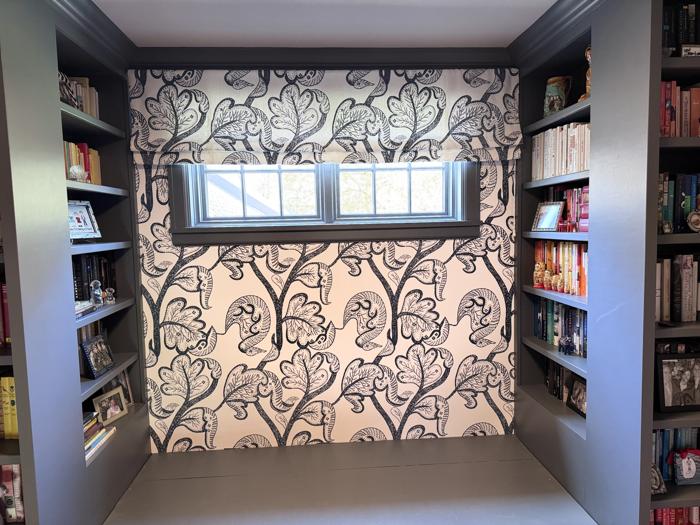 Large-scale floral between built-in bookshelves