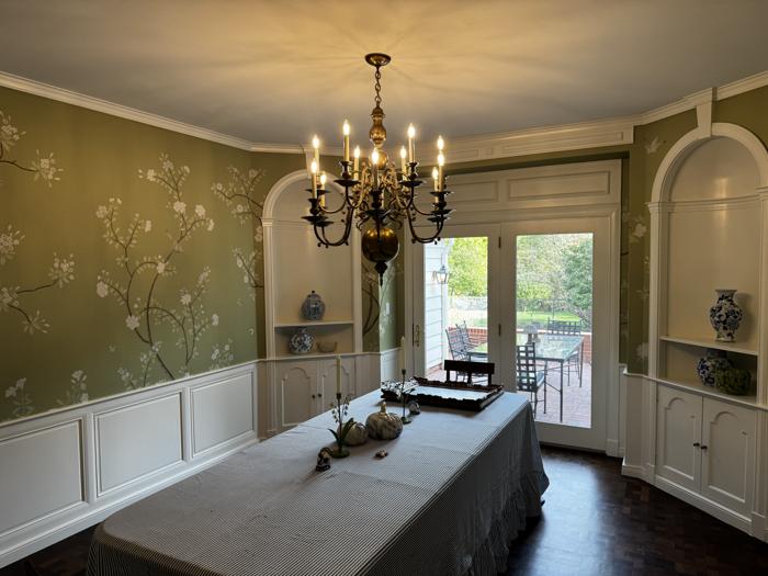 Green chinoiserie dining room with chandelier