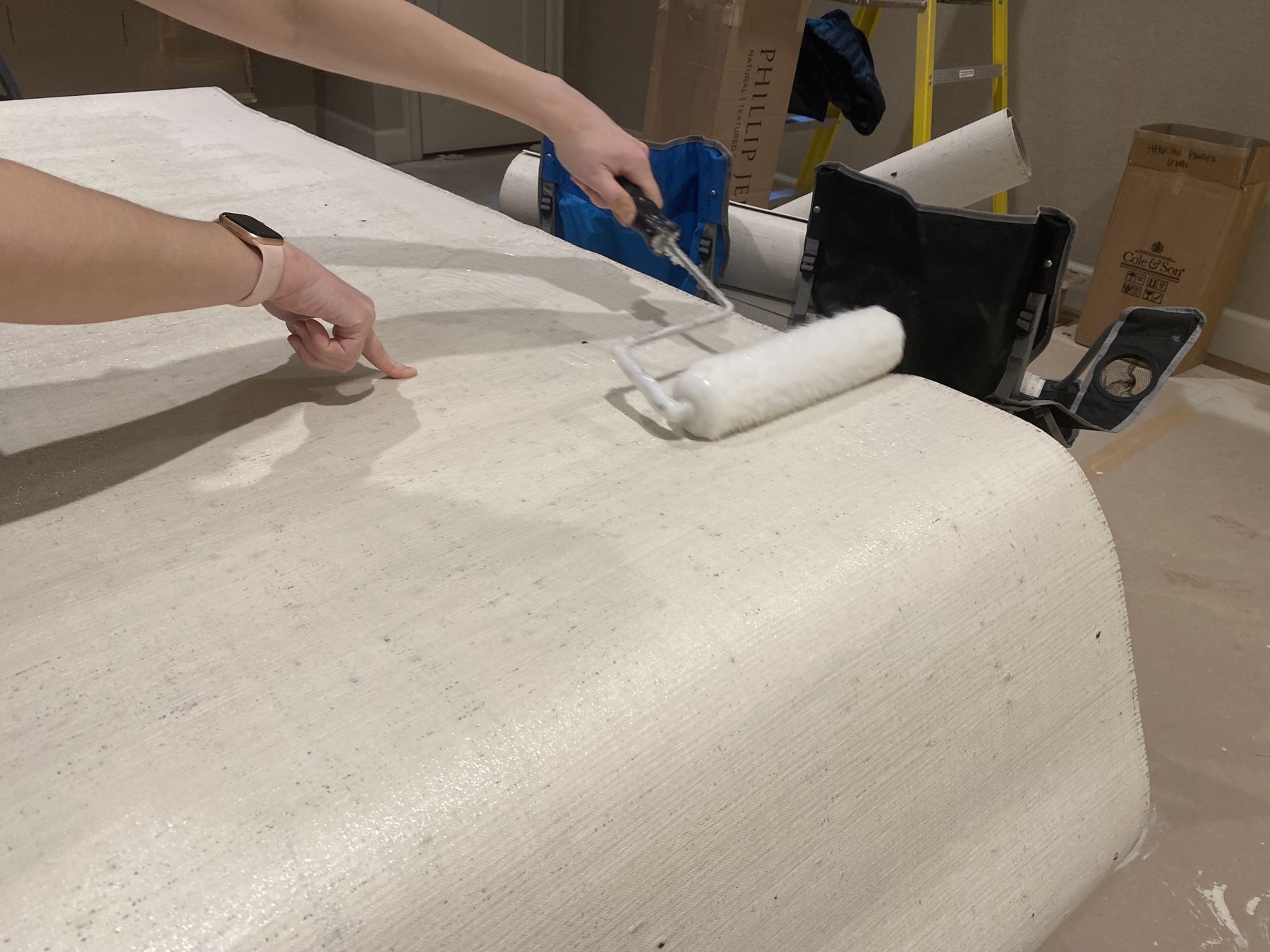 Rolling paste onto a wallpaper panel